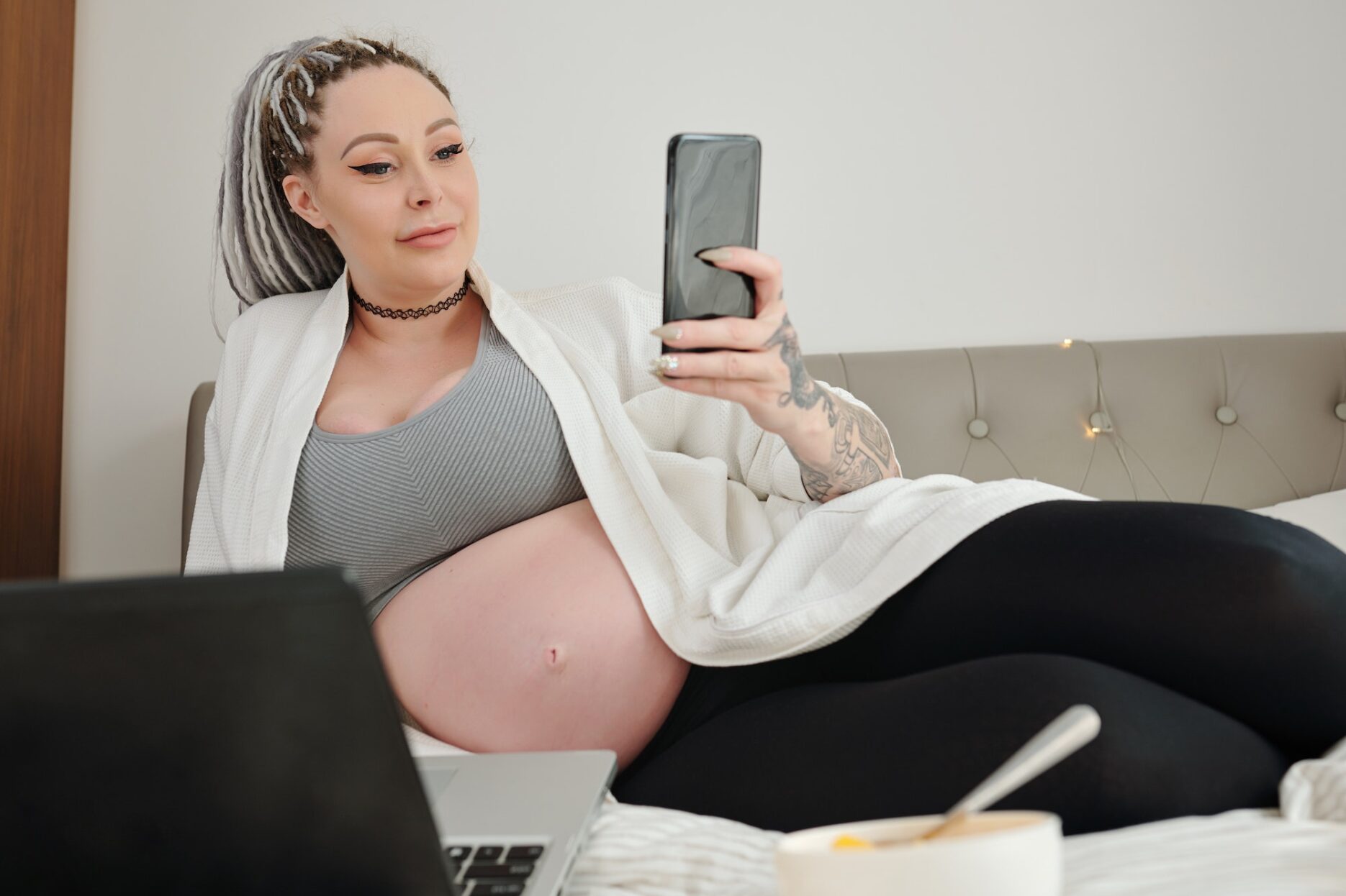 Pregnant woman checking social media