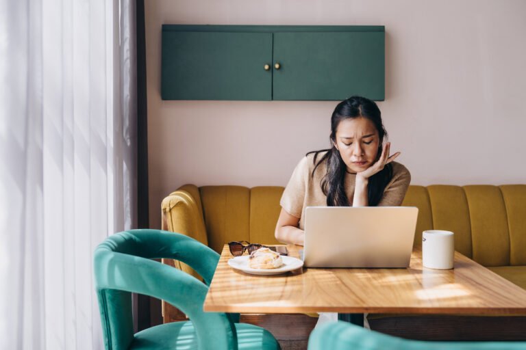 Doula working on computer in a cafe