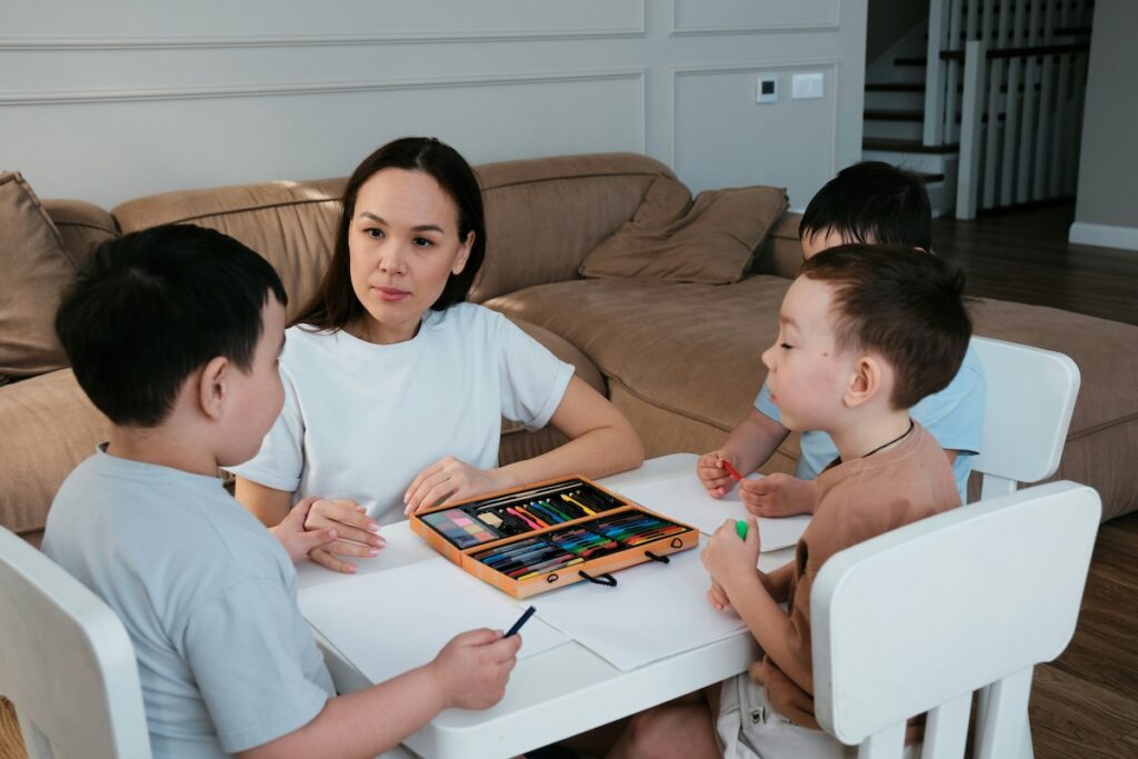 Mom talks to kids while coloring about her work as a doula.