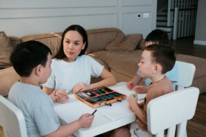 Mom talks to kids while coloring about her work as a doula.