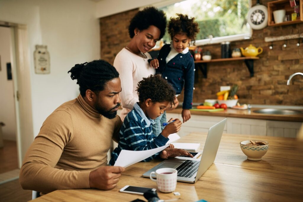 Mom and dad working with kids in the kitchen