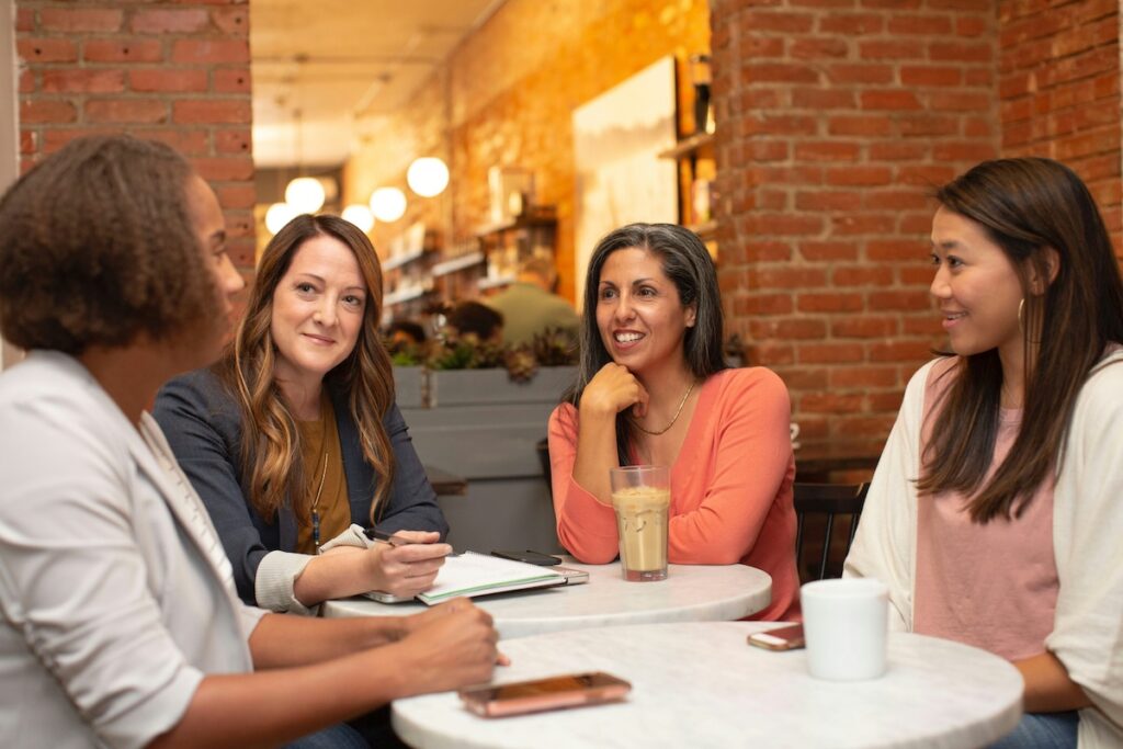 Women networking for business at a table.