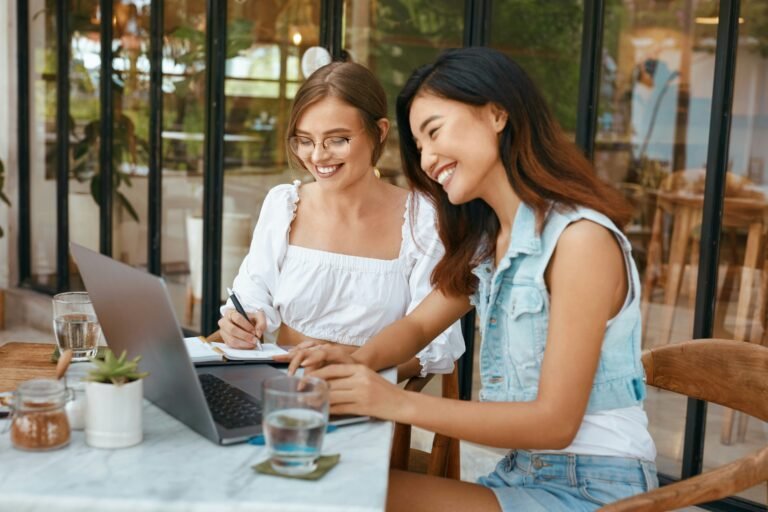 Two women working at a table together.