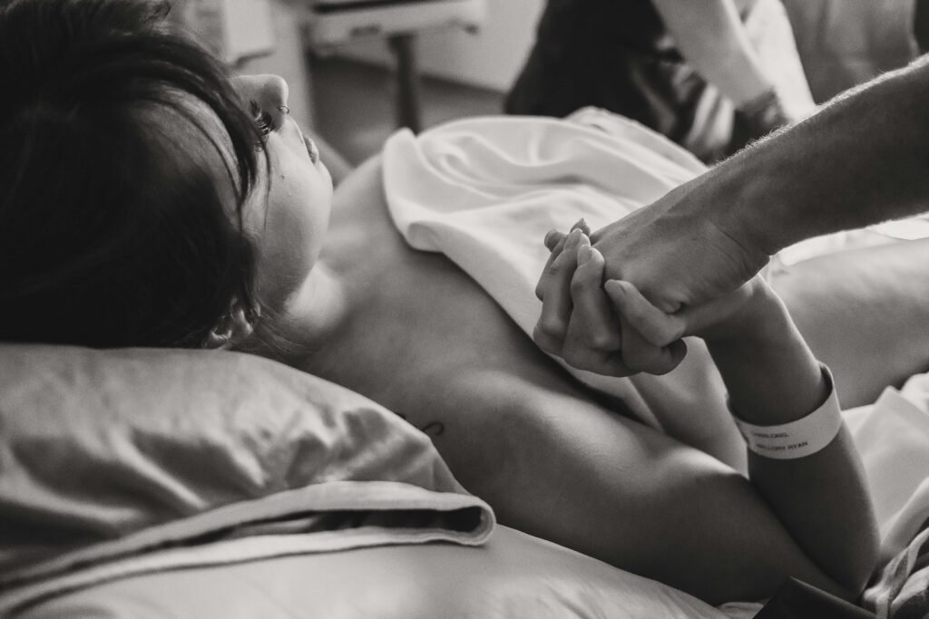 Doula holding hands.