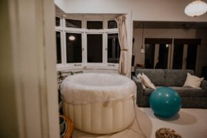 Birth tub and birth ball set up and waiting for a doula to arrive.