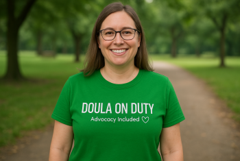 Doula on Duty Doula on Duty t-shirt being worn by a smiling white doula.